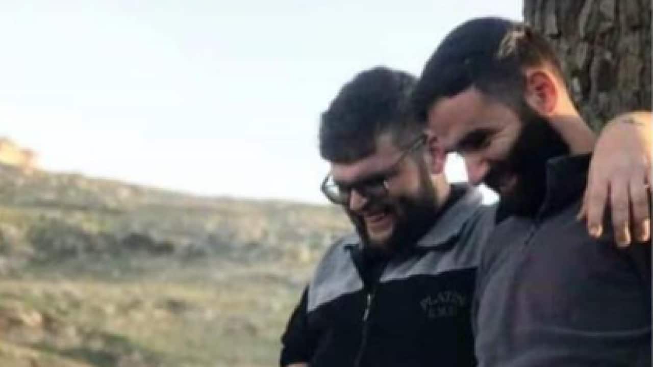 Two men hugging and laughing