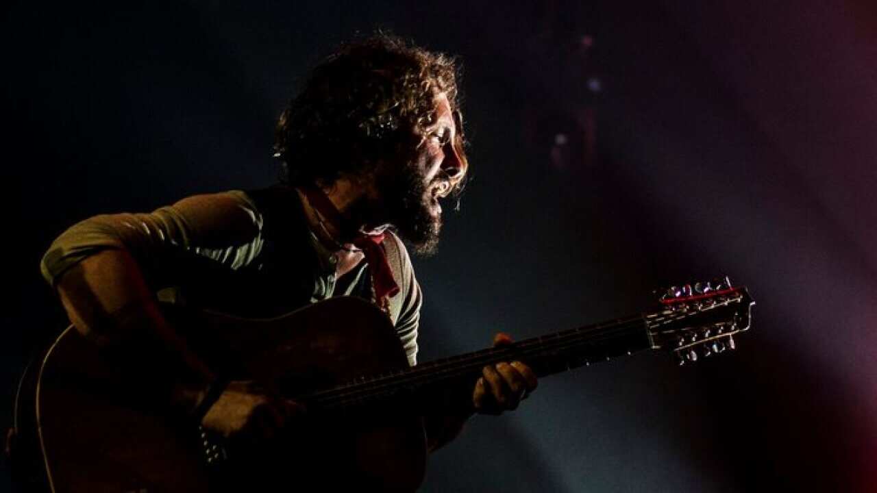 epa04172752 John Butler, lead vocalist and guitarist from the John Bulter Trio, performs on stage at the 25th Bluesfest in Byron Bay, Australia, 19 April 2014. Australia's premier blues and roots music festival runs from 17 to 21 April. EPA/KABIR DHANJI