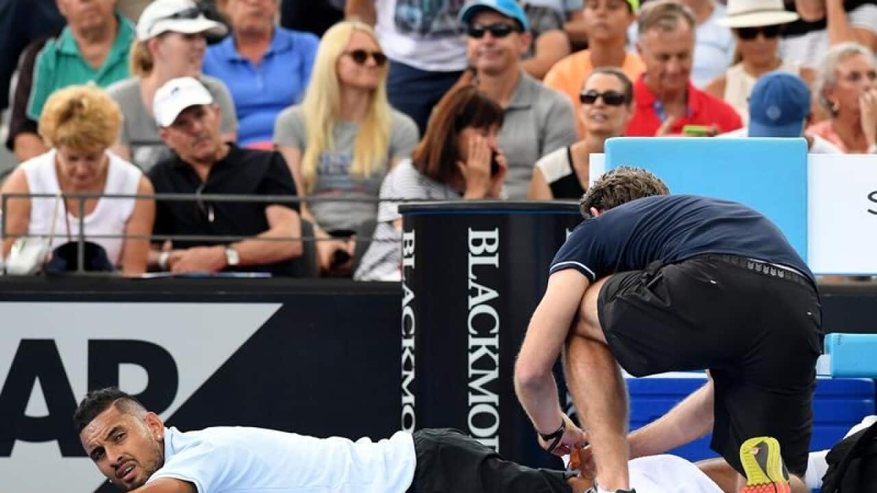 Nick Kyrgios is treated by medical staff at the Brisbane International