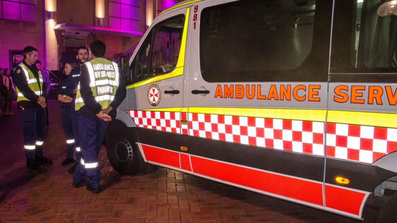 Ambulance service stands by during search for a missing man who reportedly fell off a pier at Darling Harbour around 11pm on Friday May 23, 2014, during the opening night of Vivid Sydney festival.