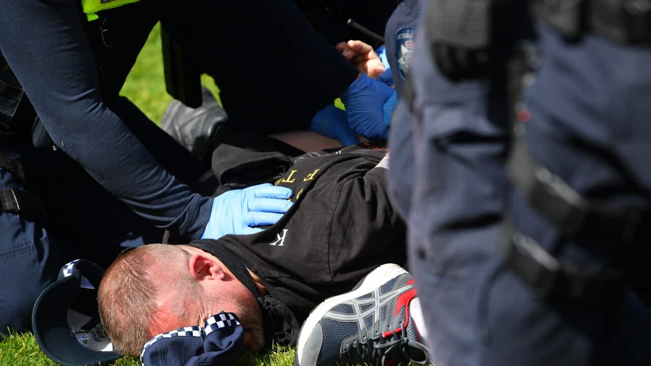 A protester is arrested by Victorian Police Officers outside of the Shrine of Remembrance in Melbourne