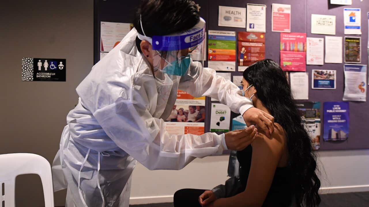 Healthcare worker Suman Rai (left) vaccinates a patient at a pop-up COVID-19 vaccination clinic in Broadmeadows, Melbourne.