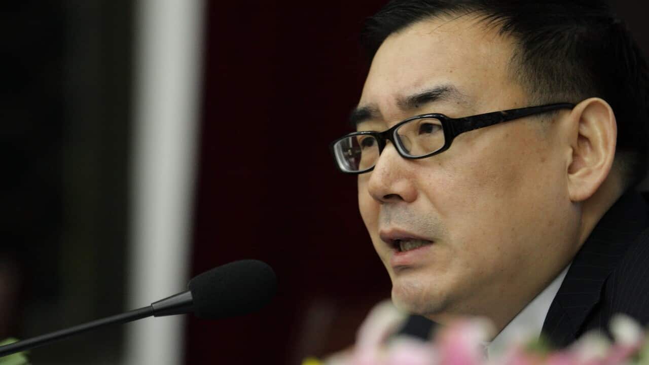 Yang Hengjun speaking into a microphone