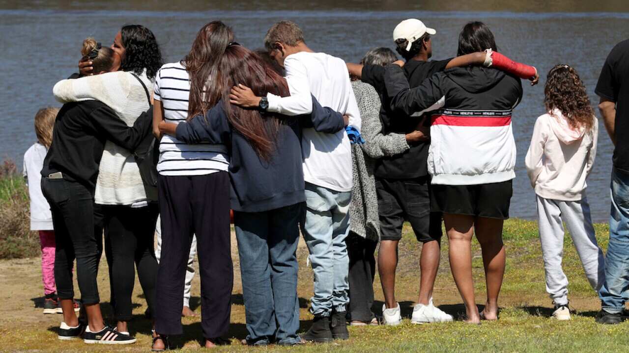 Children mourning the loss of their friends, drowned during a police chase in Perth, W.A.