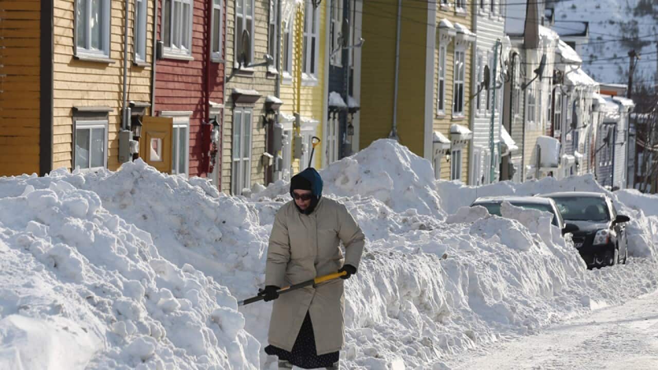 A woman shovels out after a winter storm hit St.John's. N.L