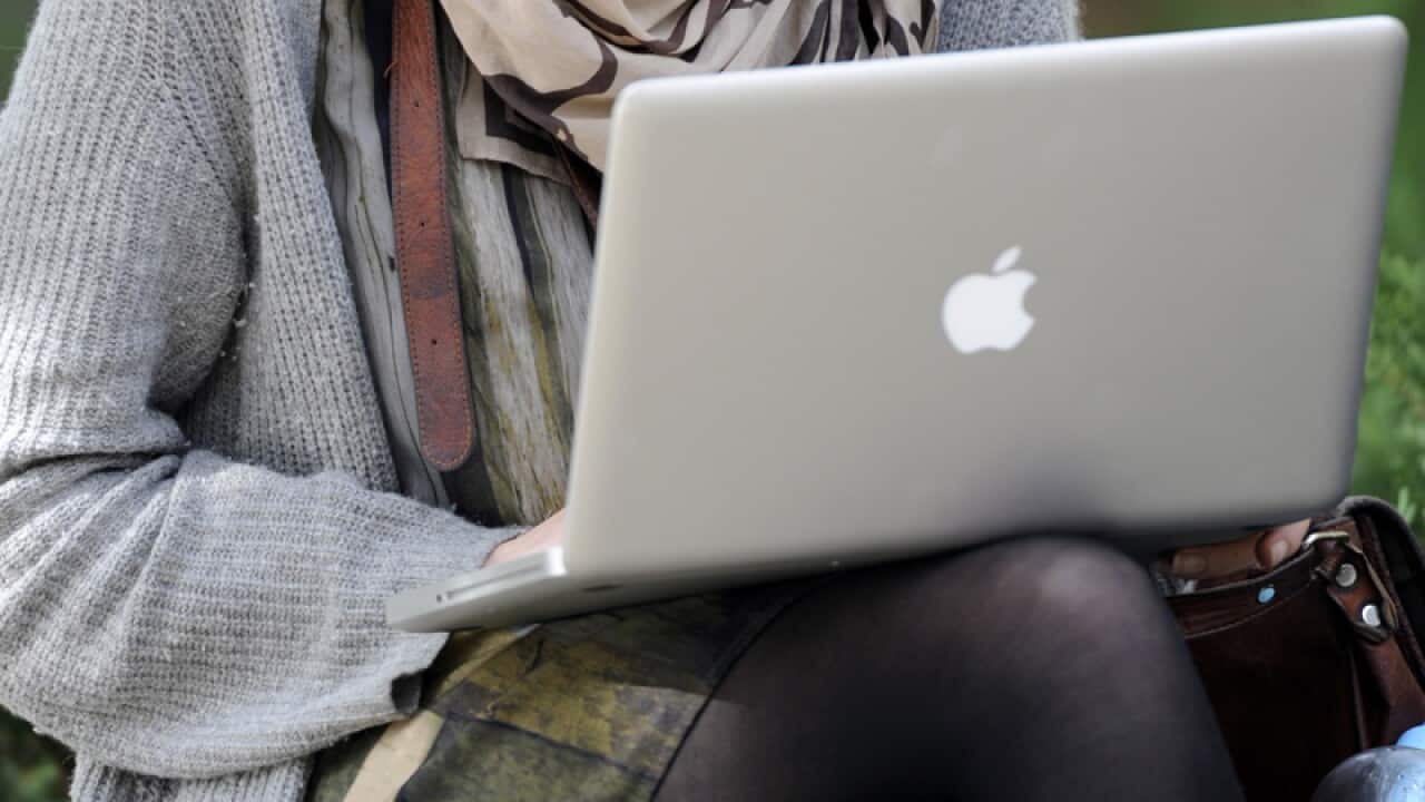 A tertiary student with a laptop