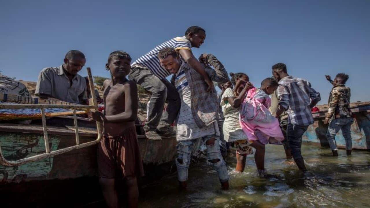 Tigray refugees arrive on the banks of the Tekeze River on the Sudan-Ethiopia border
