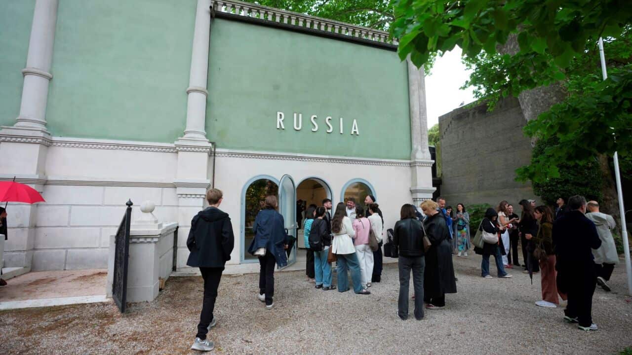 Visitors stand outside the Russia pavilion at the Venice 2026 Biennale Art, Italy, Tuesday, May 5, 2026. (AP Photo-Luca Bruno).jpg