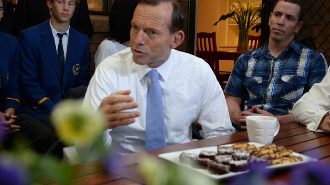 Opposition leader Tony Abbott at the Carey family home in Adelaide