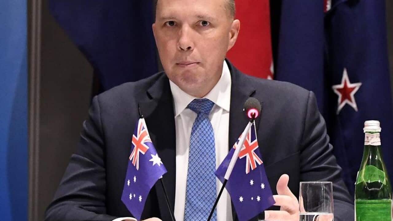 Peter Dutton looks on during the Five Country Ministerial meeting.