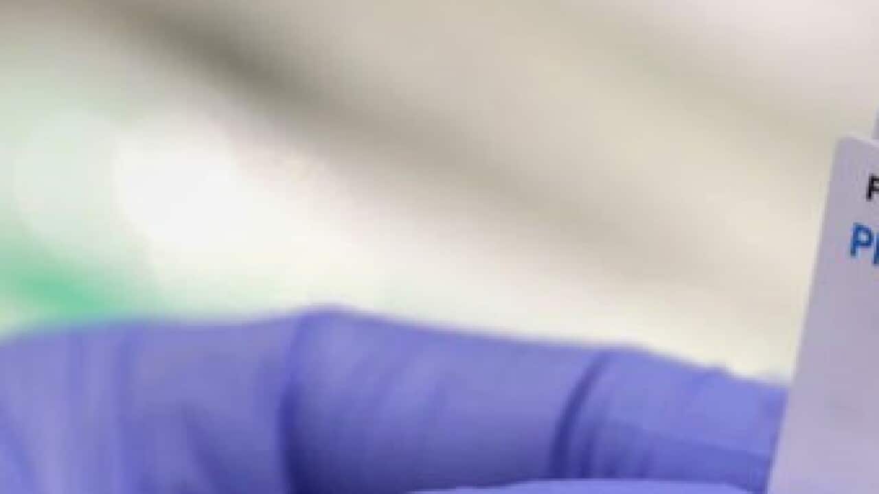 A health care worker prepares a syringe with the Pfizer vaccine on the opening day of a COVID-19 mass vaccination clinic in Perth