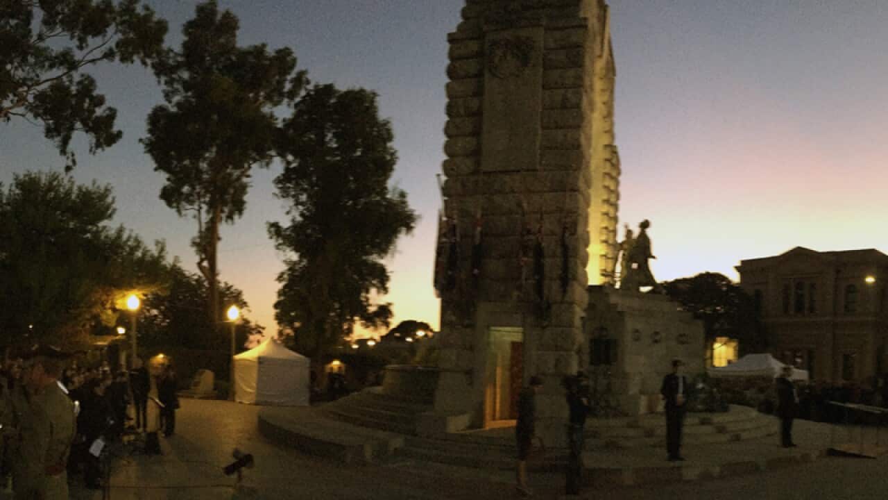 Dawn breaks during the Anzac Day dawn service in Adelaide