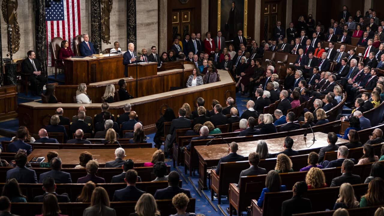 Joe Biden standing and speaking to members of the US congress who are seated.