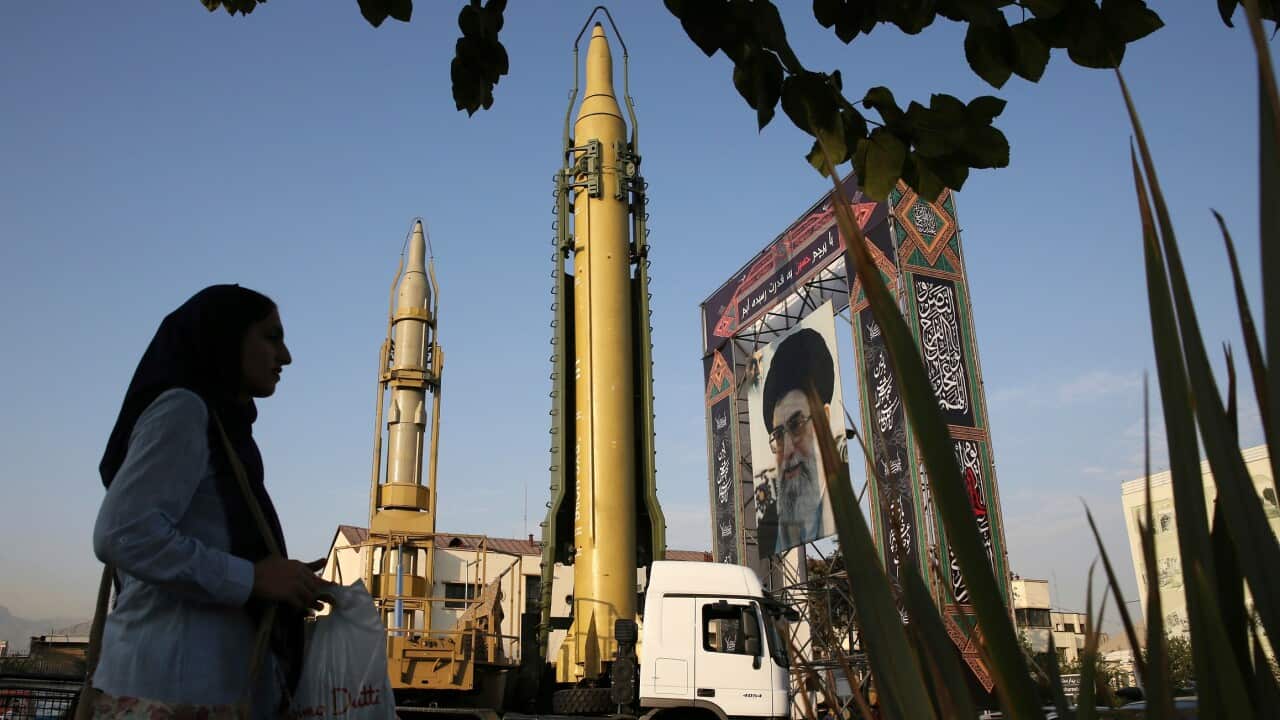 File photo, a Ghadr-H missile, a solid-fuel surface-to-surface Sejjil missile and a portrait of the Supreme Leader Ayatollah Ali Khamenei are displayed at Baharestan Square in Tehran, Iran.