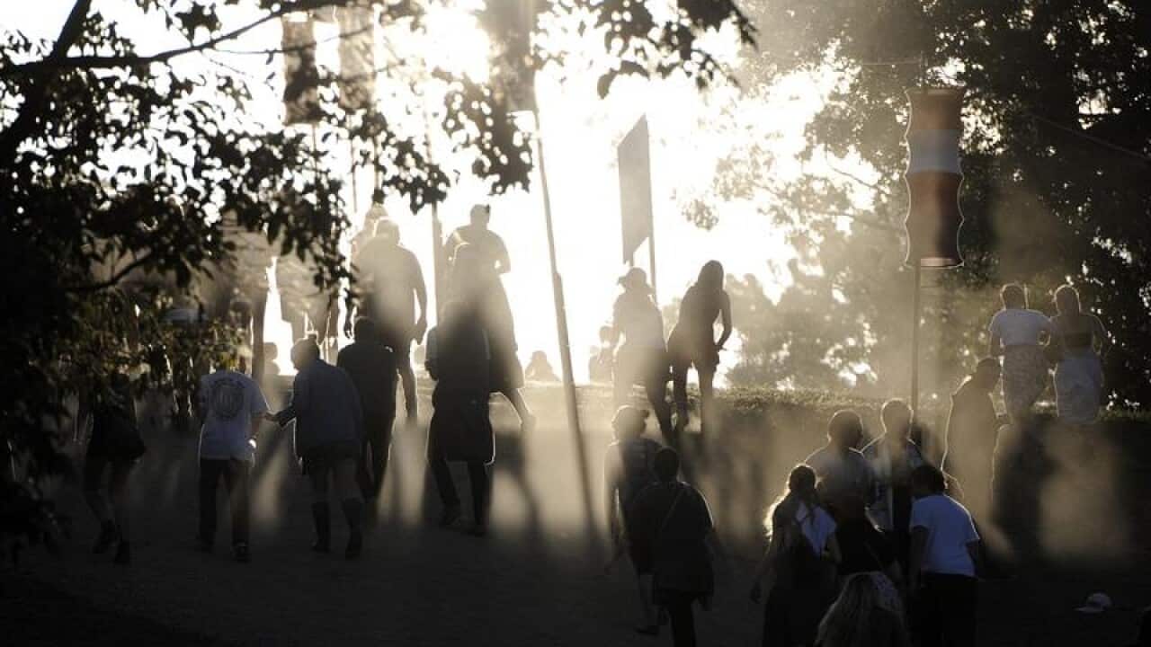 Music fans make their way to the main stage area at music festival.