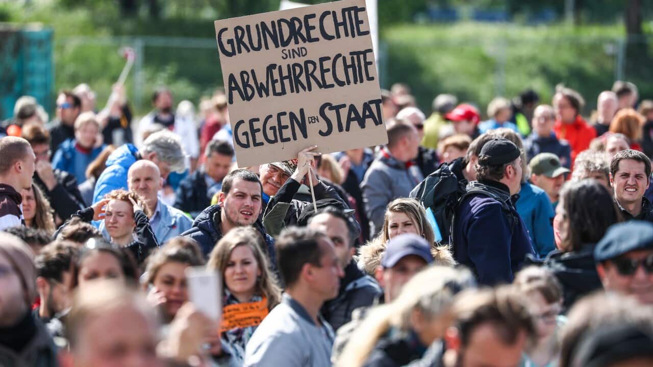 02 May 2020, Baden-Wuerttemberg, Stuttgart: People take part in a rally against the Corona restrictions at Cannstatter Wasen. Photo: Christoph Schmidt/dpa