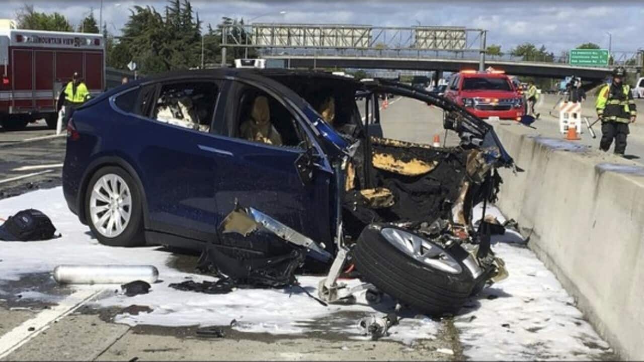Emergency personnel work a the scene where a Tesla electric SUV crashed into a barrier on U.S. Highway 101 in Mountain View, Calif.
