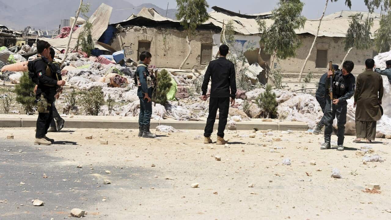 Security personnel inspect at the site of an explosion in Kandahar, Afghanistan on May 22.