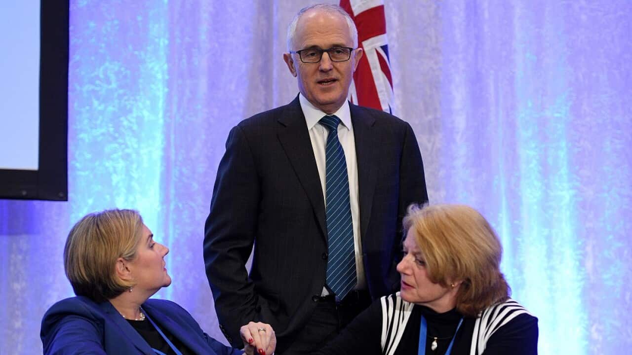 Australian Prime Minister Malcolm Turnbull speaks with Council members Hollie Hughes (left) and Helen Kroger as he arrives at the 59th Liberal Party Council Meeting in Sydney, Friday, June 23, 2017. (AAP Image/Dan Himbrechts) NO ARCHIVING