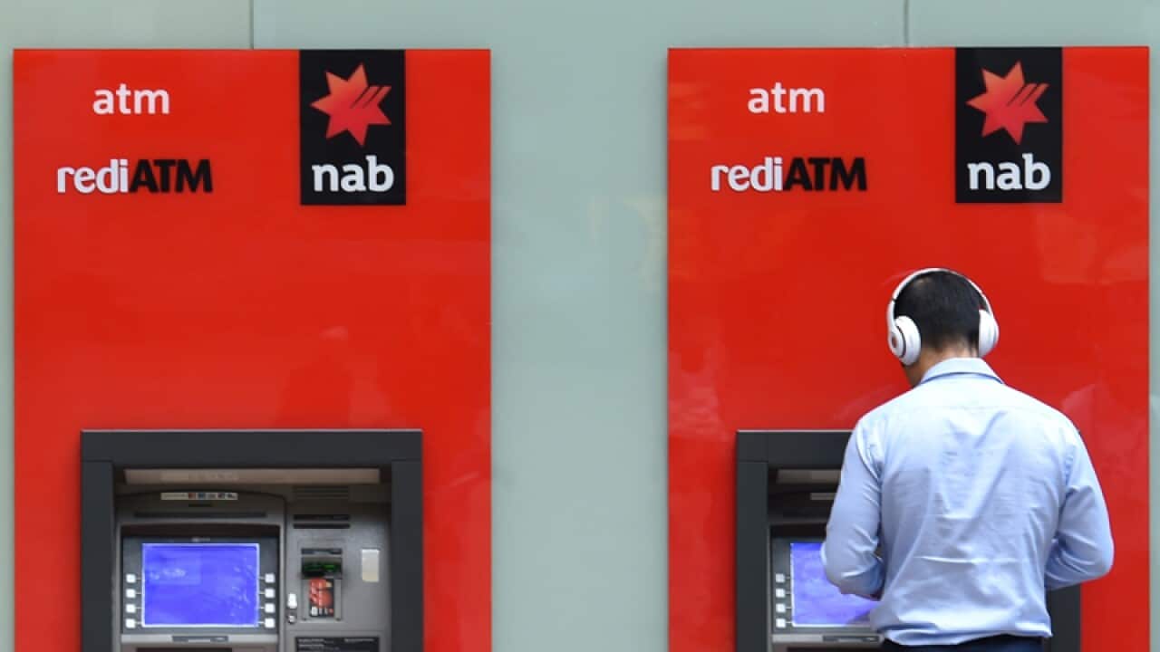 A man uses a National Australia Bank (NAB) ATM