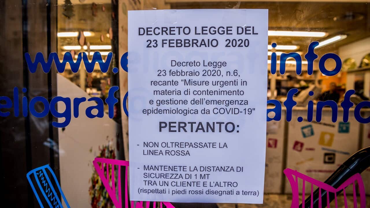 Keep a distance of one metre from people, warns a sign at the Eliografica store in Milan