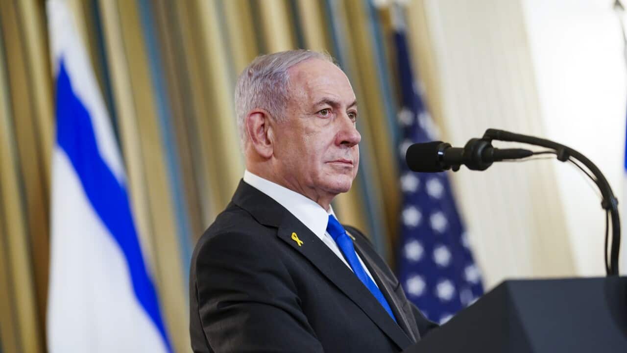 Israeli Prime Minister Netanyahu stands at a podium in front of an Israeli flag.