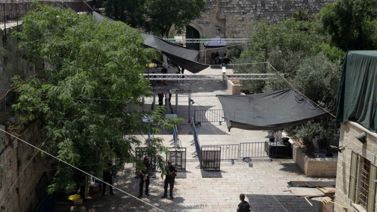 Israeli border police officers stand guard near newly installed cameras at the entrance to the Al Aqsa Mosque compound in Jerusalem's Old City