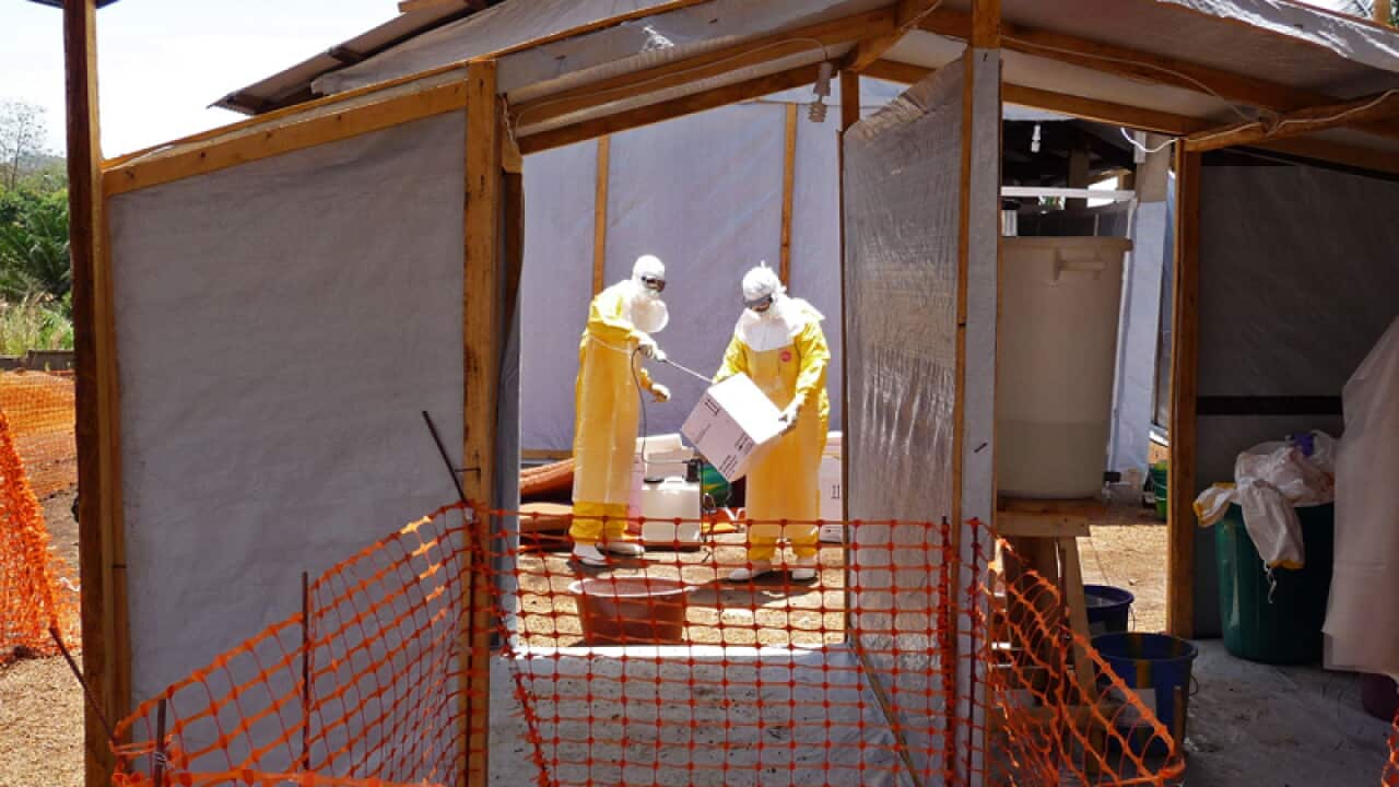 Healthcare workers prepare isolation and treatment areas for Ebola