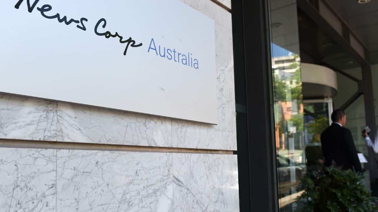 An employee enters the News Corp Australia office