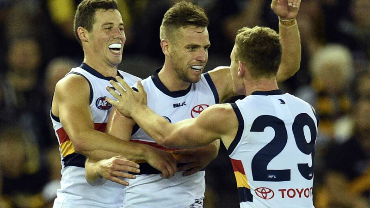 Adelaide Crows players celebrate after kicking a goal