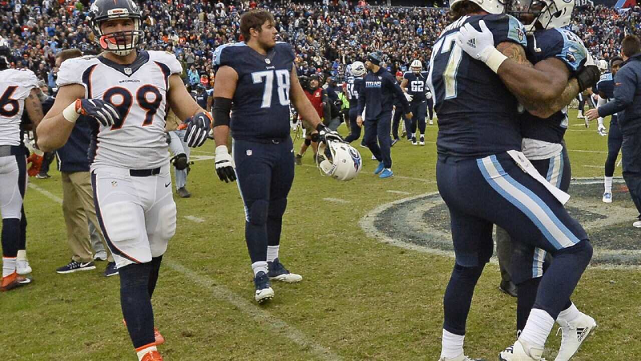 Tennessee Titans' Taylor Lewan (77) celebrates with DeMarco Murray