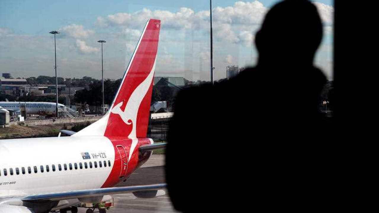 A man waits at Sydney Airport.