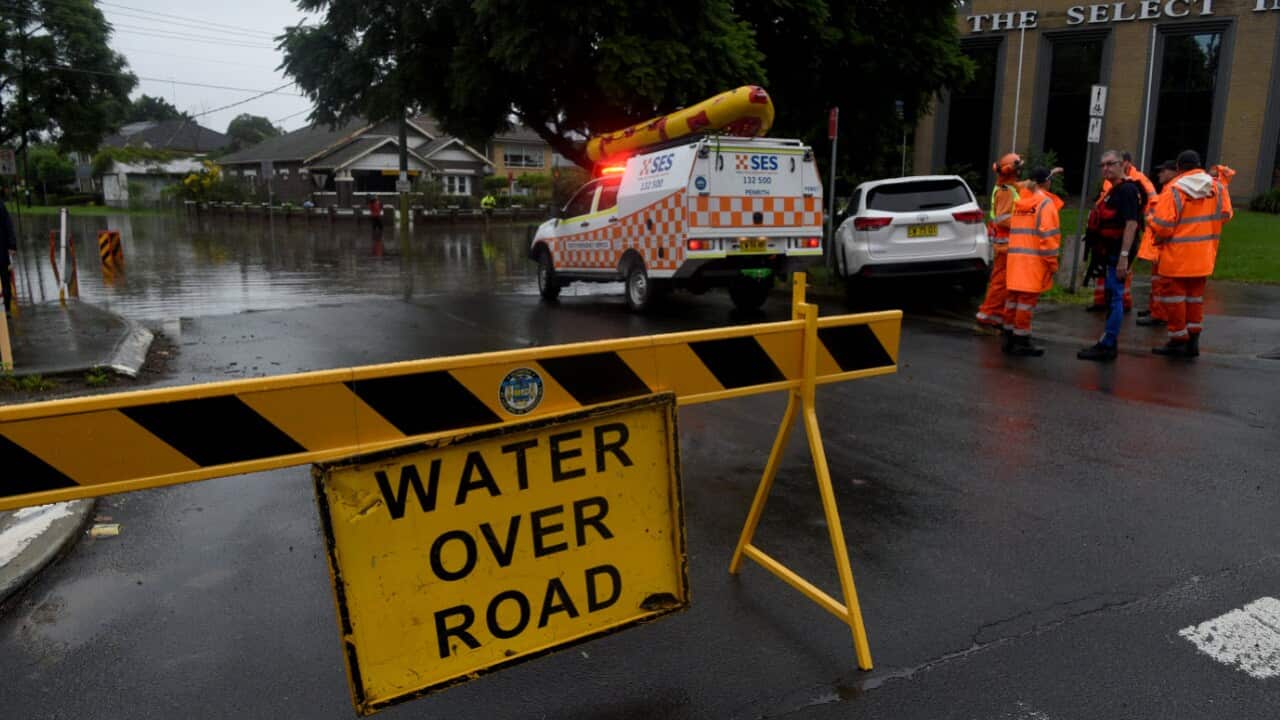 Floodwater submerges the road on the corner of Ladbury Ave and Memorial Ave, in Penrith, NSW, Sunday, 21 March, 2021.