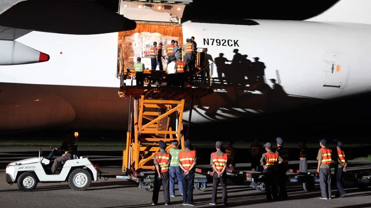 Workers unload emergency aid sent from the United States(AAP Image - AP Photo - APTN).jpg