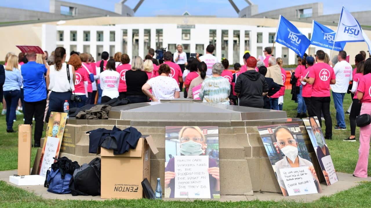 Aged care workers are seen protesting outside Parliament House in Canberra,