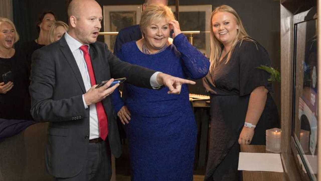 Norway's Prime Minister, Erna Solberg, centre, and her daughter Ingrid Solberg Finnes react to the results of Solberg's Conservative party