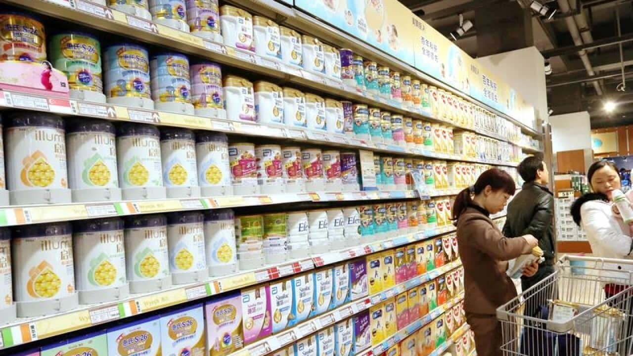 Chinese customers shop for baby formula at a supermarket