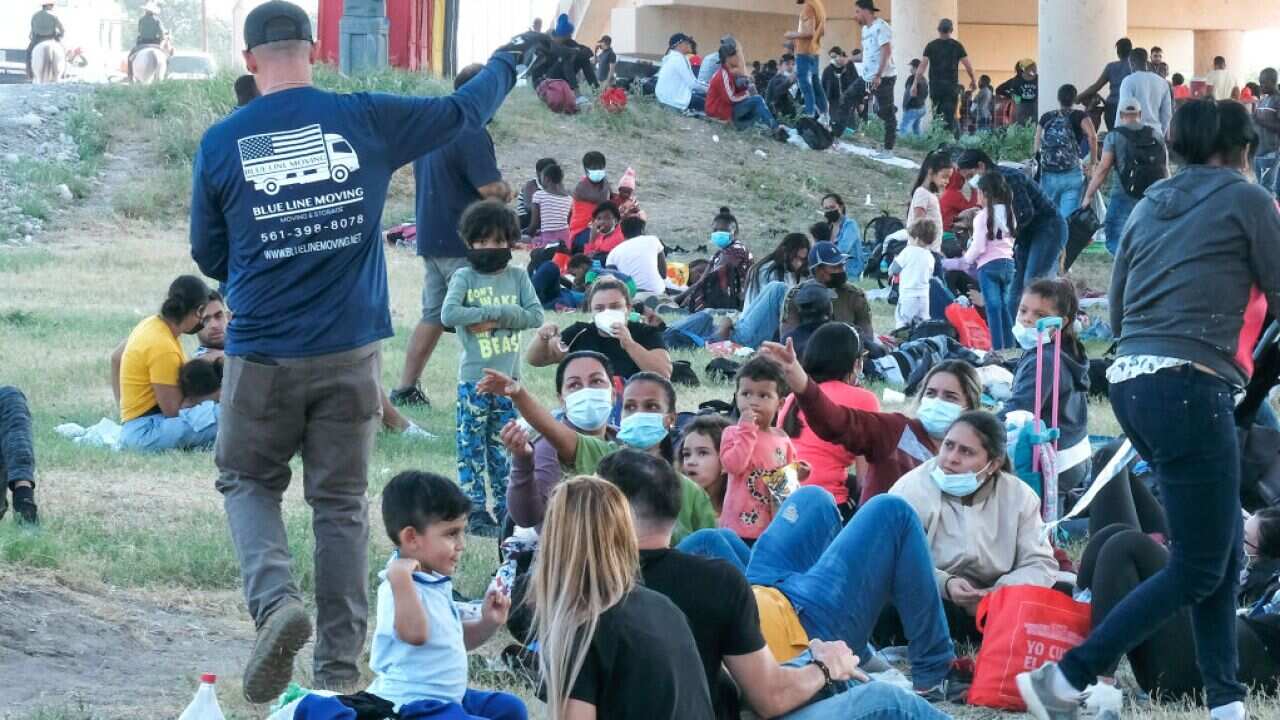 Migrants are seen at the Rio Grande near the Del Rio-Acuna Port of Entry in Del Rio, Texas, on 18 September 2021.