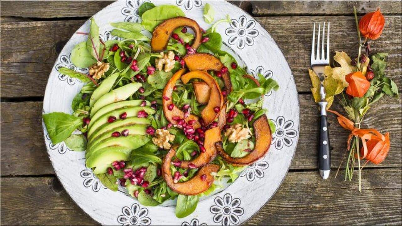 Autumnal salad with squash, pomegranate seeds, avocado and walnuts
