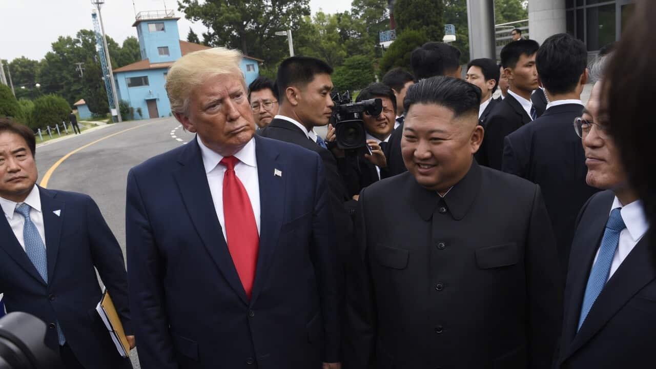 President Donald Trump, left, North Korean leader Kim Jong Un, center
