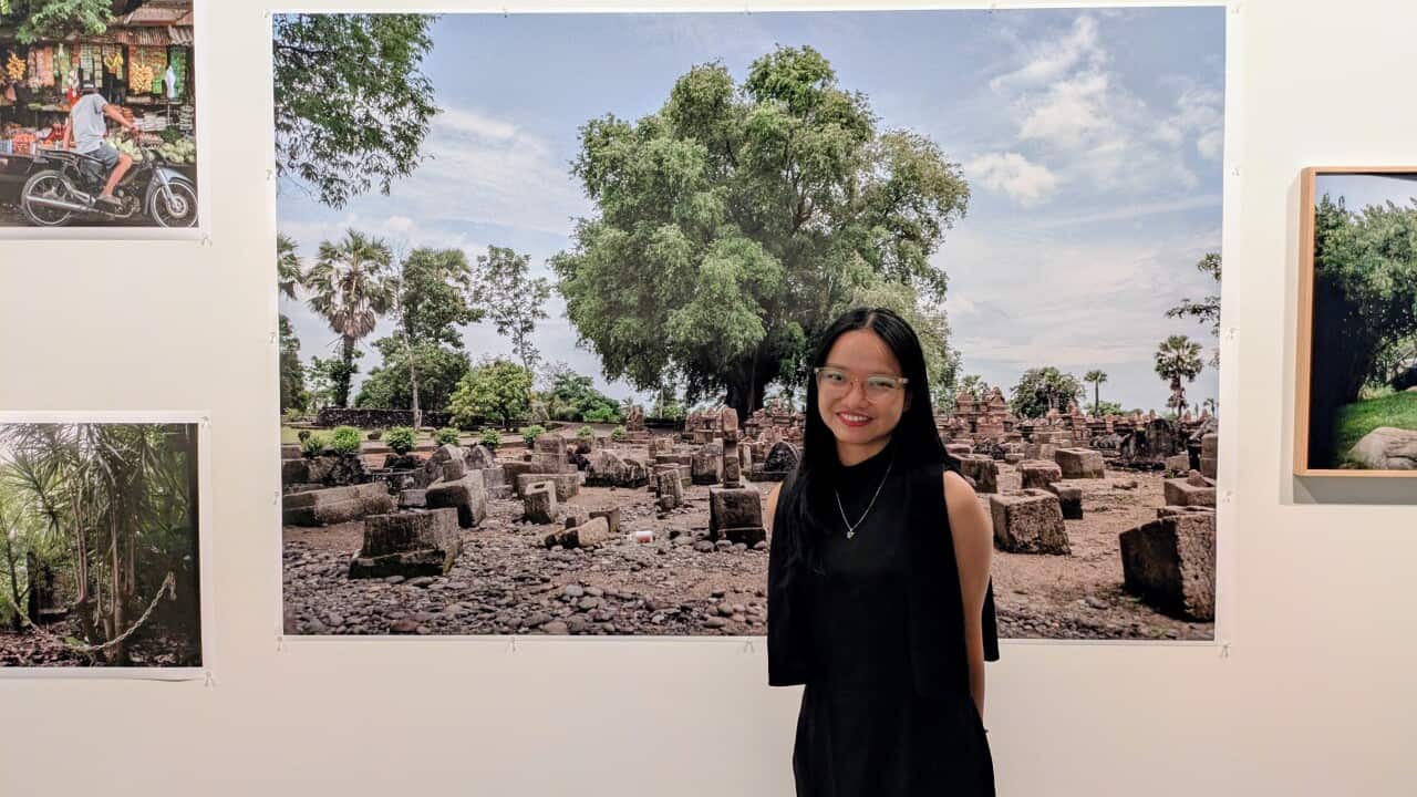Aziziah Diah Aprilya in front of one of her photographs from 'Under the Tamarind Tree', at the Awakening Histories exhibition at Monash University Museum of Art, Melbourne. Credit_ SBS Indonesian_Anne Parisianne.jpg