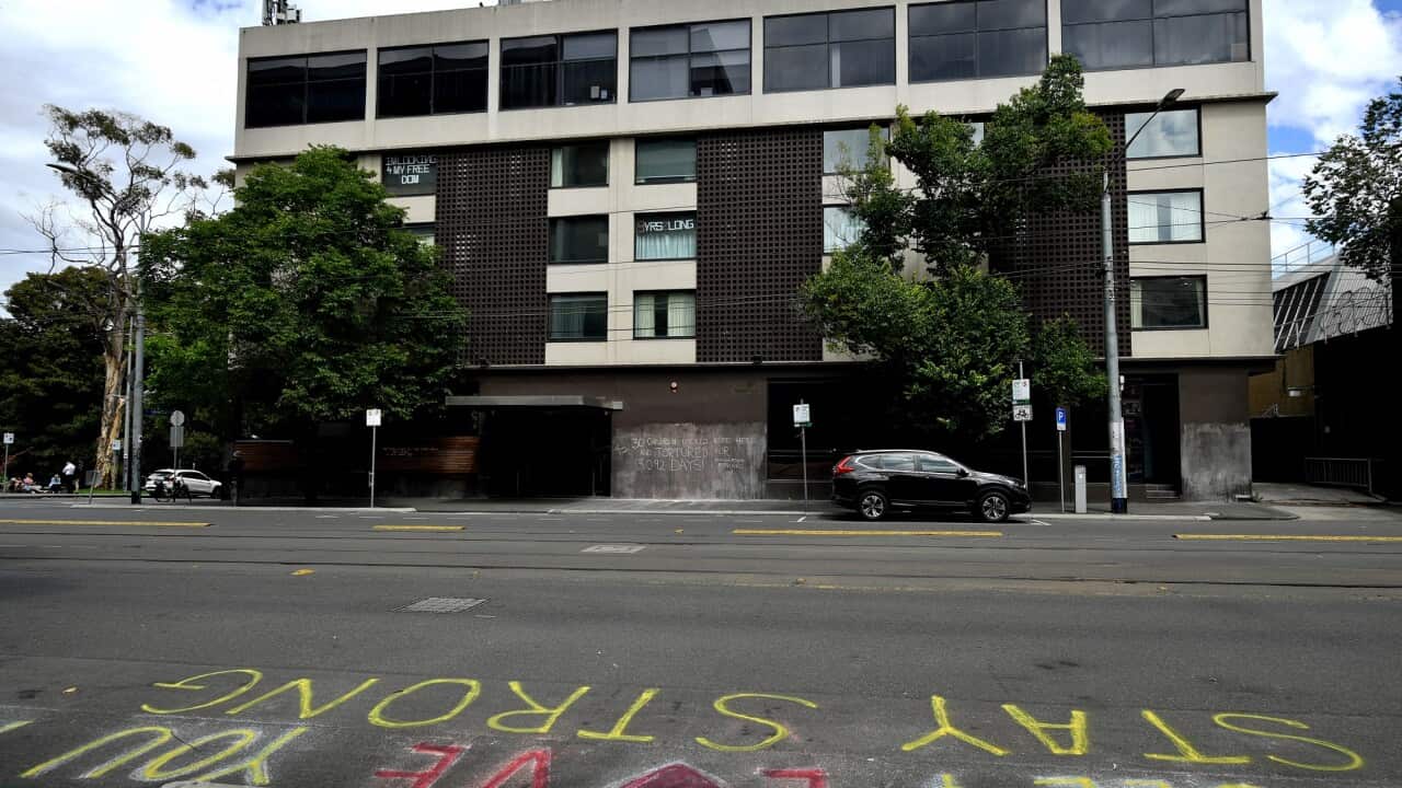 Park Hotel building in Melbourne. Activists have used chalk on the pavement to write the message 'Stay Strong'.