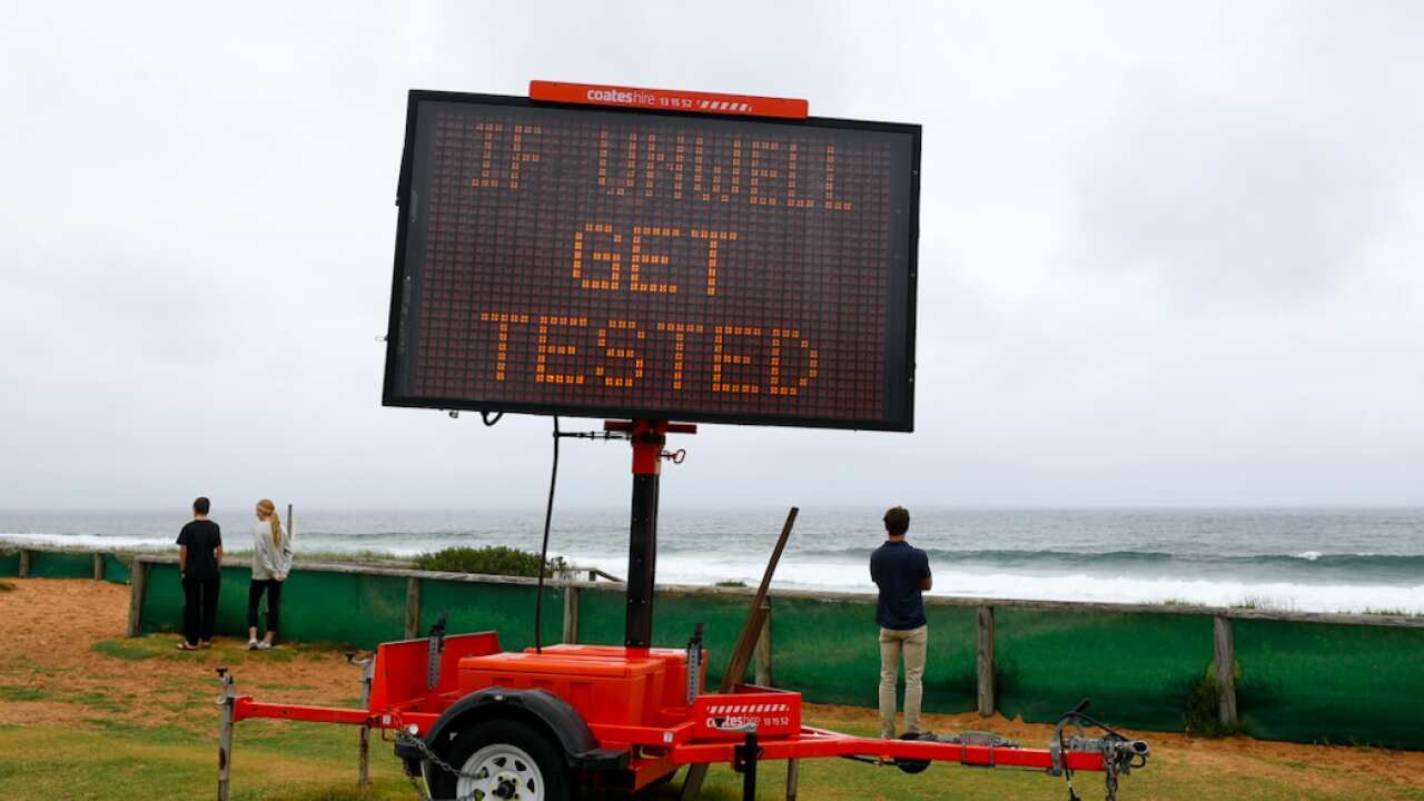 Public health messaging is seen on a sign at north Narrabeen beach, on Sydney’s Northern Beaches, Saturday, December 19, 2020