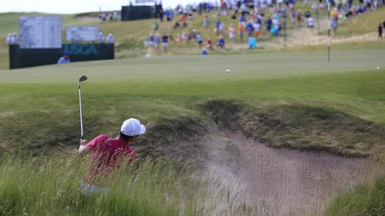 Jason Day plays a bunker shot