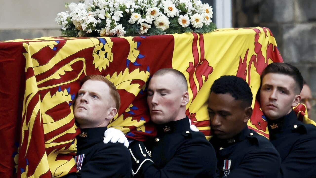 Four pallbearers carrying the coffin of Queen Elizabeth II