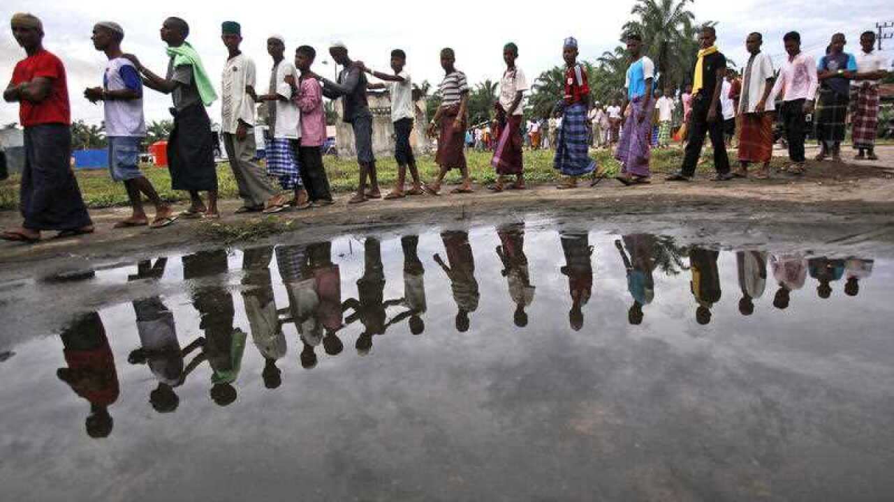 Rohingya migrants queue up for food at a temporary shelter in Bayeun, Aceh province, Indonesia, Monday, May 25, 2015.