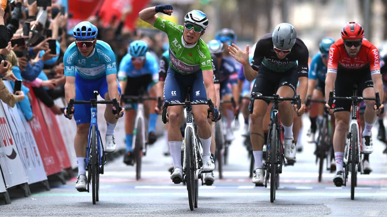 Jasper Philipsen celebrates as he crosses the finish line