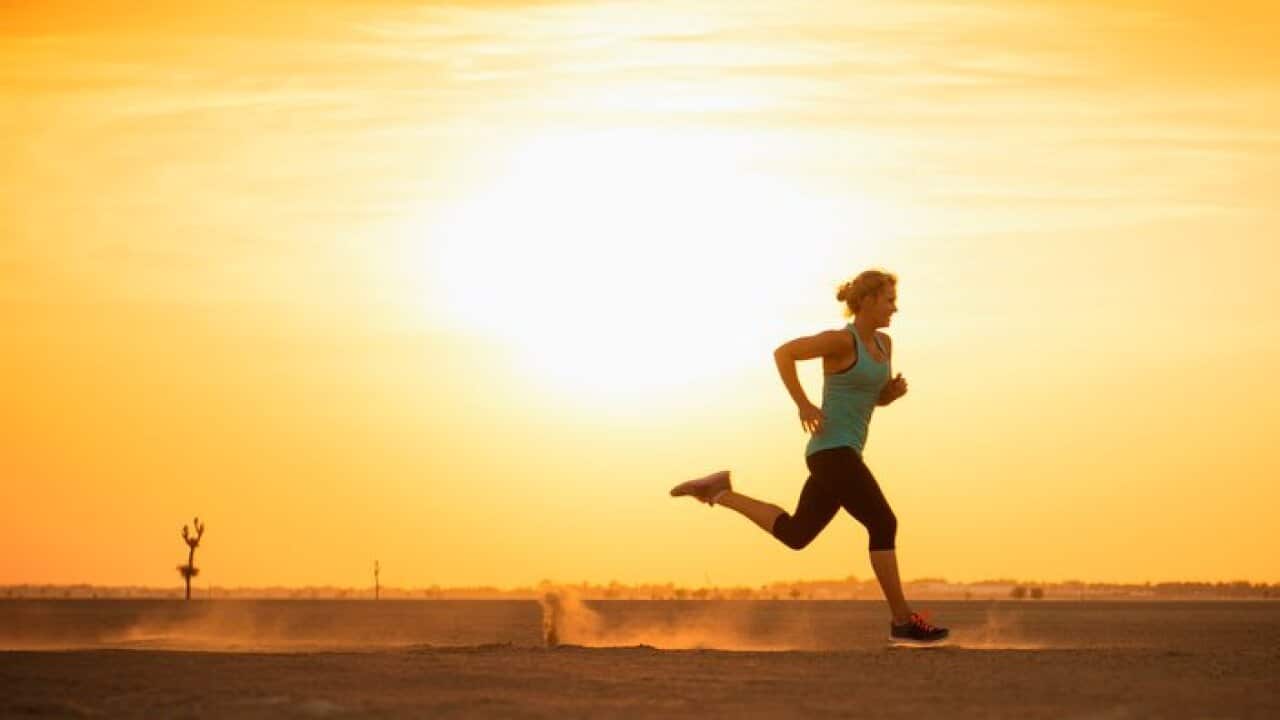 Caucasian woman running in desert