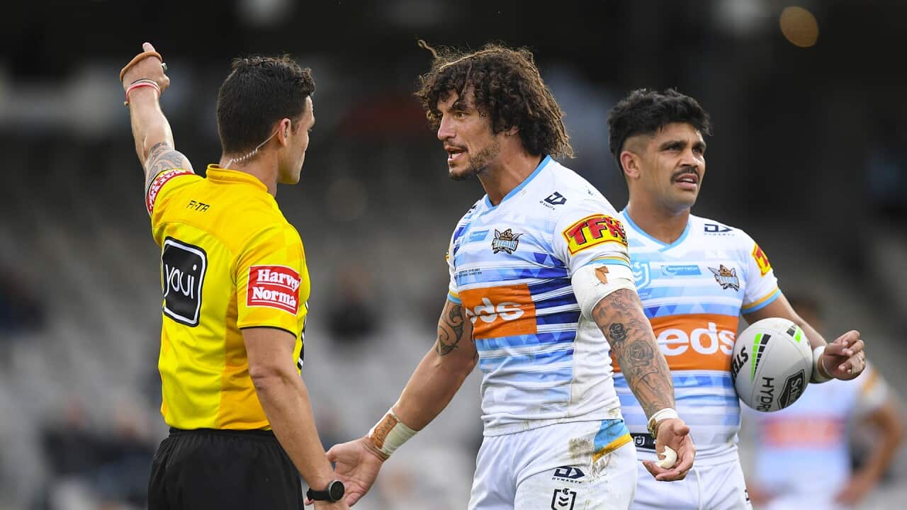 Kevin Proctor of the Titans is called by referee Henry Perenara following an incident involving biting the forearm of Shaun Johnson