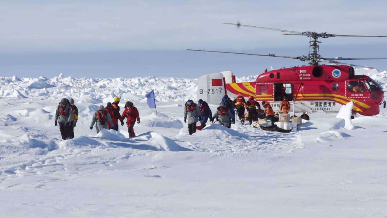 Passengers from the Akademik Shokalskiy disembarking from the Chinese rescue helicopter - AAP-1.jpg